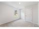 Sun-filled carpeted bedroom featuring a window and a closet door at 1109 Foxberry Ln, Maiden, NC 28650
