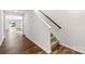 Bright hallway featuring hardwood floors, leading to a carpeted staircase and open living spaces at 1109 Foxberry Ln, Maiden, NC 28650