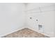 Functional laundry room with patterned flooring, shelving and utility connections at 1109 Foxberry Ln, Maiden, NC 28650