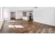 Spacious open-concept living area with hardwood floors and views of the kitchen area at 1109 Foxberry Ln, Maiden, NC 28650