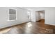 Bright living room with hardwood floors and large windows allowing ample natural light at 1109 Foxberry Ln, Maiden, NC 28650