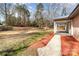 Expansive backyard with covered porch with mulch and gravel accents at 1111 Barrington St, Wadesboro, NC 28170