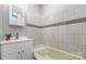 Clean bathroom with updated tile, modern vanity, and tub at 1111 Barrington St, Wadesboro, NC 28170