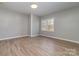 Neutral bedroom featuring modern flooring and natural light from a window at 1111 Barrington St, Wadesboro, NC 28170