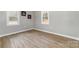 Light-filled bedroom featuring two windows and modern wood look flooring at 1111 Barrington St, Wadesboro, NC 28170