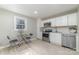 Well-lit kitchen with white cabinets, stainless steel appliances, and tile backsplash at 1111 Barrington St, Wadesboro, NC 28170