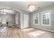 Bright living space boasts hardwood floors, large windows, and a stylish chandelier at 1111 Barrington St, Wadesboro, NC 28170