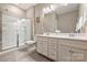 Clean bathroom featuring a double sink vanity, tiled floors, and a glass-enclosed shower at 11206 Grenfell Ave, Huntersville, NC 28078