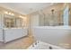 Bathroom featuring double vanity sinks, soaking tub, and tiled shower at 11206 Grenfell Ave, Huntersville, NC 28078