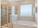 Bathroom featuring a soaking tub and tiled shower at 11206 Grenfell Ave, Huntersville, NC 28078