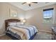 Cozy bedroom with a comfortable bed, soft carpet, and a bright window, creating a relaxing retreat at 11206 Grenfell Ave, Huntersville, NC 28078