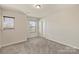 Bedroom featuring plush carpet and a window with natural light at 11206 Grenfell Ave, Huntersville, NC 28078