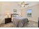 Bedroom featuring plush carpet, ceiling fan, and large window at 11206 Grenfell Ave, Huntersville, NC 28078