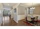 Open-concept dining room featuring hardwood floors, chandelier, and adjacent living spaces at 11206 Grenfell Ave, Huntersville, NC 28078