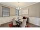 Cozy dining room with wainscoting, chandelier, and seating for four, perfect for intimate meals at 11206 Grenfell Ave, Huntersville, NC 28078
