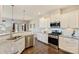 Open kitchen with granite counters, stainless steel appliances, hardwood floors, and a view to the dining area at 11206 Grenfell Ave, Huntersville, NC 28078