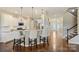 Well-lit kitchen with modern bar seating, stainless steel appliances, and hardwood floors at 11206 Grenfell Ave, Huntersville, NC 28078