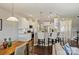 Bright, open kitchen with white cabinets, stainless steel appliances, and bar seating at 11206 Grenfell Ave, Huntersville, NC 28078