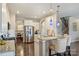 Kitchen with stainless steel appliances, granite countertops, white cabinets, island seating, and hardwood flooring; adjacent to dining area at 11206 Grenfell Ave, Huntersville, NC 28078