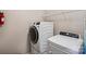 Convenient laundry room with a modern front-load washer and dryer, plus overhead shelving at 11206 Grenfell Ave, Huntersville, NC 28078