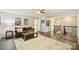 Spacious living room with a cozy sofa, large area rug, and a view of the staircase at 11206 Grenfell Ave, Huntersville, NC 28078