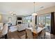 Bright living room featuring a fireplace, hardwood floors, neutral furnishings, and view to dining area and sliding glass doors at 11206 Grenfell Ave, Huntersville, NC 28078