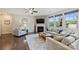 Bright living room with fireplace, large windows, and comfortable seating, creating a welcoming atmosphere at 11206 Grenfell Ave, Huntersville, NC 28078