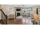 Cozy living room featuring a fireplace, hardwood floors, neutral furnishings, with a view of the staircase at 11206 Grenfell Ave, Huntersville, NC 28078