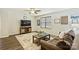 Comfortable living area featuring a plush sofa, large TV, and modern decor at 11206 Grenfell Ave, Huntersville, NC 28078