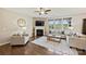 Comfortable living room with hardwood floors, fireplace, neutral-toned furniture, and large windows providing ample natural light at 11206 Grenfell Ave, Huntersville, NC 28078