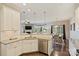 Open kitchen and living area with granite countertops, stainless appliances, hardwood floors, and view of living room and dining area at 11206 Grenfell Ave, Huntersville, NC 28078