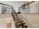 Elegant staircase with iron railings, wooden steps, and decor at 11206 Grenfell Ave, Huntersville, NC 28078