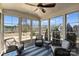 Bright sunroom with ceiling fan, large windows with backyard views, and wicker furniture at 11206 Grenfell Ave, Huntersville, NC 28078
