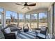 Bright sunroom featuring large windows, comfortable seating, and scenic outdoor views at 11206 Grenfell Ave, Huntersville, NC 28078