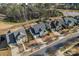 Aerial view of a street with multiple homes, green space, and a pond at 12018 Grey Partridge Dr, Charlotte, NC 28278