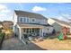 Two-story home with covered patio, fire pit, outdoor furniture, and a playset in the backyard at 12018 Grey Partridge Dr, Charlotte, NC 28278