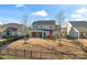 Large backyard with a playset and covered patio with lounge seating and a fire pit at 12018 Grey Partridge Dr, Charlotte, NC 28278