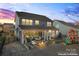 The backyard features a covered patio with seating, a fire pit, and a play structure at 12018 Grey Partridge Dr, Charlotte, NC 28278