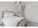 Bright bedroom with neutral carpet, ceiling fan, and a large window offering a view of the interior at 12018 Grey Partridge Dr, Charlotte, NC 28278