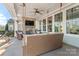 Covered patio with stone fireplace, ceiling fan, a TV and porch swing for comfortable outdoor living at 12018 Grey Partridge Dr, Charlotte, NC 28278