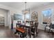 Bright dining room featuring a stylish light fixture, dark wood table and rustic wood bench at 12018 Grey Partridge Dr, Charlotte, NC 28278