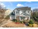 Charming two-story home with a well-manicured lawn, inviting front porch, and a two-car garage at 12018 Grey Partridge Dr, Charlotte, NC 28278