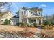 Charming two-story home with light blue siding, a manicured front yard, and inviting front porch at 12018 Grey Partridge Dr, Charlotte, NC 28278