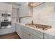 Close-up of modern kitchen featuring stainless steel appliances, quartz countertops, and a stylish backsplash at 12018 Grey Partridge Dr, Charlotte, NC 28278