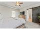 Spacious main bedroom with tray ceiling, ceiling fan, bathroom with barn door and connecting room at 12018 Grey Partridge Dr, Charlotte, NC 28278