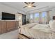 Spacious main bedroom with tray ceiling, ceiling fan, bathroom with barn door and large windows at 12018 Grey Partridge Dr, Charlotte, NC 28278
