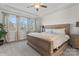 Spacious main bedroom with tray ceiling, ceiling fan and large windows that provide ample natural light at 12018 Grey Partridge Dr, Charlotte, NC 28278