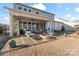 Spacious covered patio with fireplace, TV, plenty of seating and an outdoor kitchen with a grill at 12018 Grey Partridge Dr, Charlotte, NC 28278