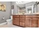 Well-lit bathroom with double vanity, granite countertops, and a glass-enclosed shower at 1244 Madison Towns Ln, Charlotte, NC 28209