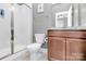Modern bathroom features a glass-enclosed shower, vanity with granite countertop, and neutral color scheme at 1244 Madison Towns Ln, Charlotte, NC 28209
